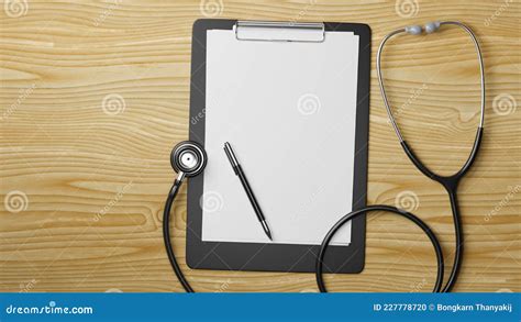 Medical Clipboard With Blank Sheet And Stethoscope On Wooden Table