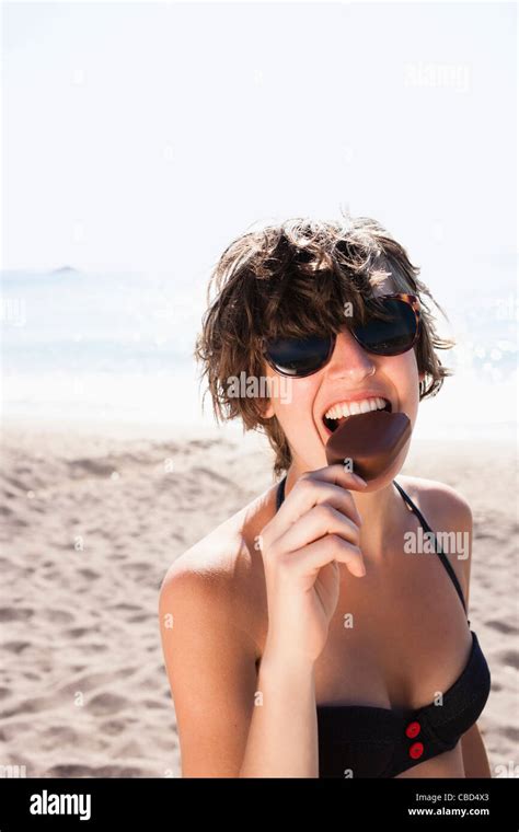 Woman Eating Ice Cream On Beach Stock Photo Alamy