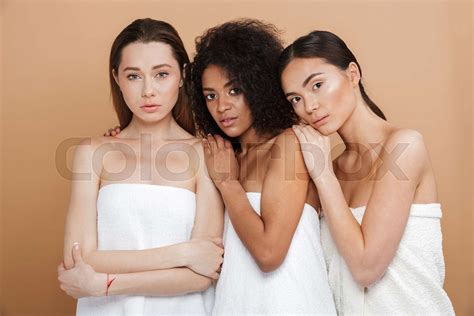 Three Sensual Naked Women Wearing In Towels Posing Together Stock