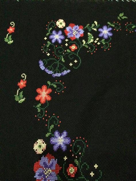 A Close Up Of A Black Cloth With Flowers On It