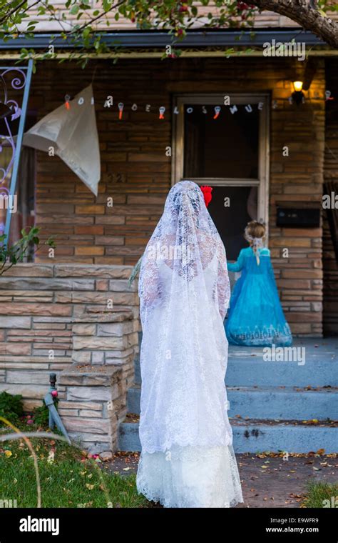 Trick or treating in costumes on Halloween night Stock Photo - Alamy