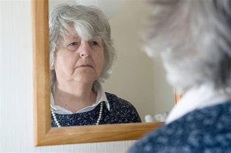 Older Woman Looking In Mirror Sad Stock Photos Pictures And Royalty Free