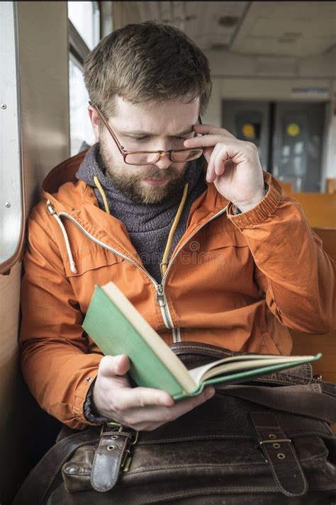 Bearded Man With Glasses Rides On The Train Home From Work And R Stock