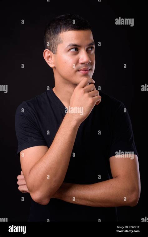 Portrait Of Young Handsome Asian Man Thinking Stock Photo Alamy