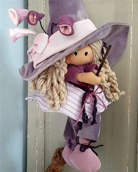 A Doll Hanging From The Side Of A Door Wearing A Hat And Holding A Wand