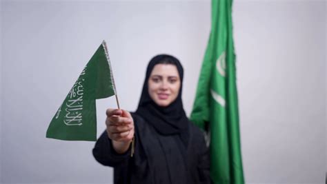 Portrait Of A Saudi Arabian Gulf Girl Holding The Flag Of Saudi Arabia