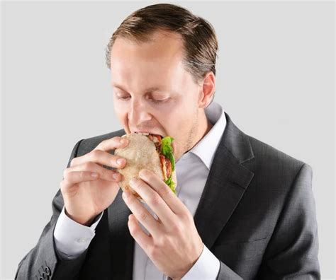 Multi Tasking Businessman Eats And Works Stock Photo By Daxiao