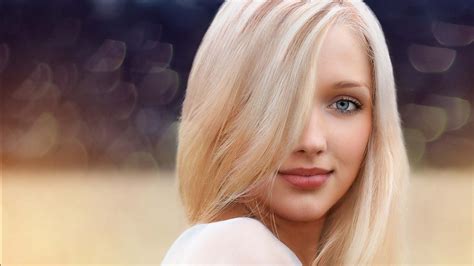 Grey Eyes Blonde Girl Model Is Standing In Blur Bokeh Background