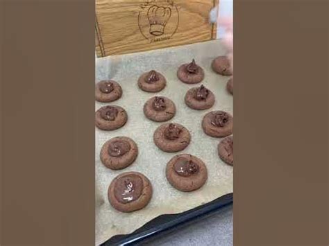 There Are Chocolate Donuts On The Cookie Sheet Ready To Be Baked In The