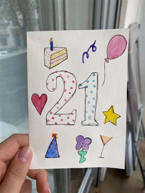 A Hand Holding Up A Card With The Number Twenty Two In Front Of It And