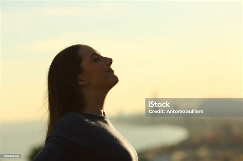 Woman Silhouette Breathing Deeply Fresh Air At Sunset Stock Photo