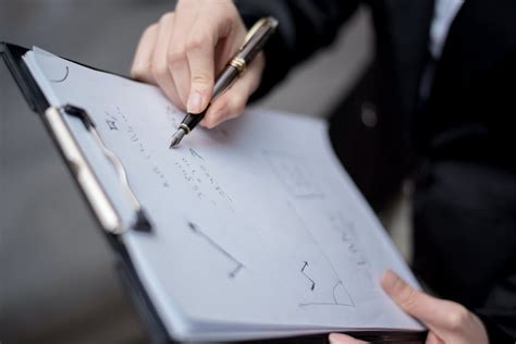 Close-Up Shot of a Person Writing on a Paper Using a Pen · Free Stock Photo