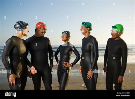 Multi Ethnic Swimmers Wearing Wetsuits And Goggles Stock Photo Alamy