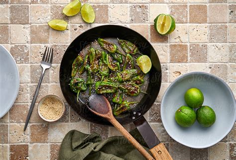 "Cooking Padron Peppers" by Stocksy Contributor "Darren Muir" - Stocksy