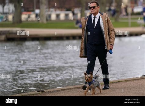 A Man Walks His Dog By The River In Stratford Upon Avon In Warwickshire