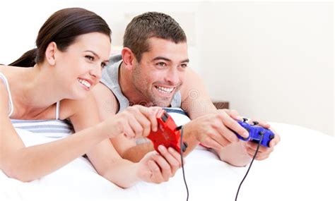 Happy Husband And Wife Playing Videogames In Bed Royalty Free Stock Image Image 14366266