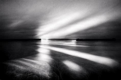 Premium Ai Image A Black And White Photo Of A Lighthouse With The Sun