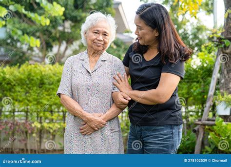 Doctor Caregiver Help And Care Asian Senior Woman Patient Walking In