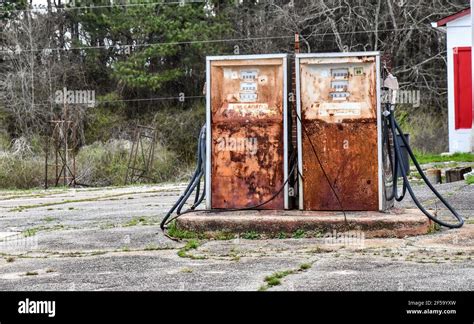 Old Rusty Vintage Petroleum Fuel Pump At Abandoned Gas Station Stock