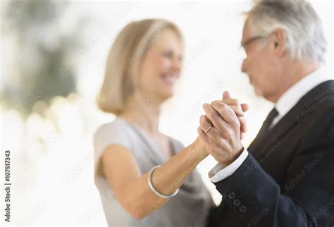 Smiling older Caucasian couple dancing Stock Photo | Adobe Stock