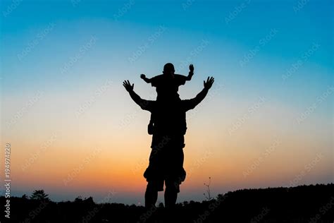 Silhouette The Son Is Riding His Father S Neck Stock Photo Adobe Stock