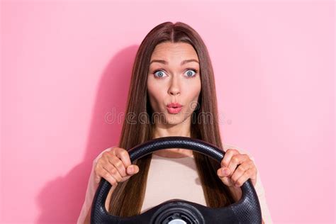 Photo Of Impressed Lady Pouted Lips Staring Arms Hold Wheel Isolated On Pink Color Background