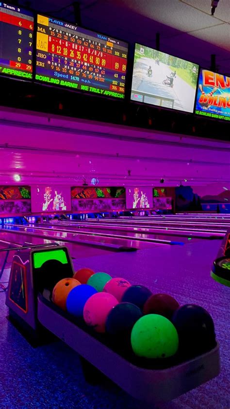 A Bowling Alley With Neon Lights And Colorful Balls In The Bowl On The