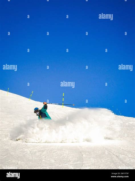 Professional skier at full speed ski downhill on fresh snow do carving in ski resort while ...