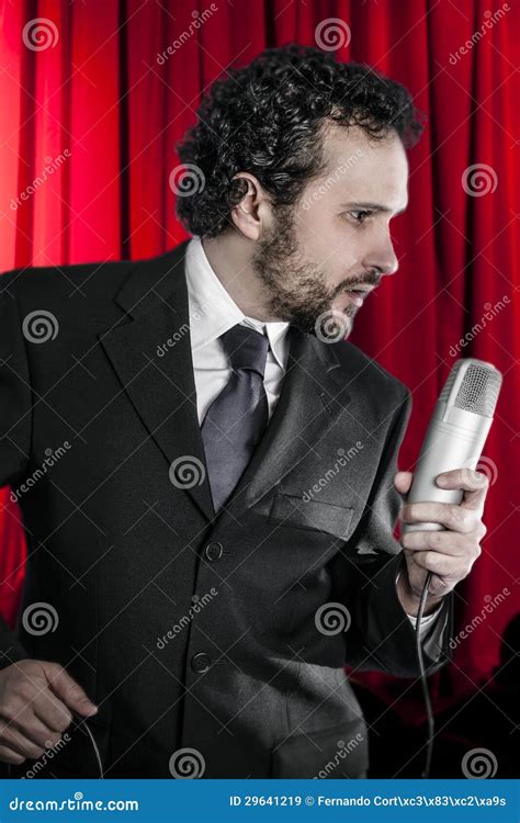 Singing Man With Black Suit And Microphone On Background Stock Image