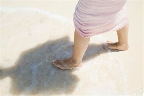 Premium Photo | Young woman having a walk at the beach barefoot