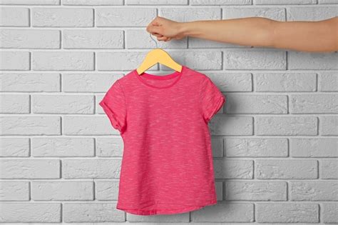 Premium Photo Blank Color T Shirt Against Brick Wall