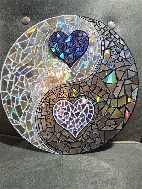 A Yin Yang Sign Made Out Of Stained Glass And Mosaic Tiles With A