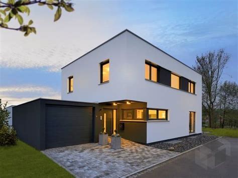 A White House With Black Garage Doors And Windows