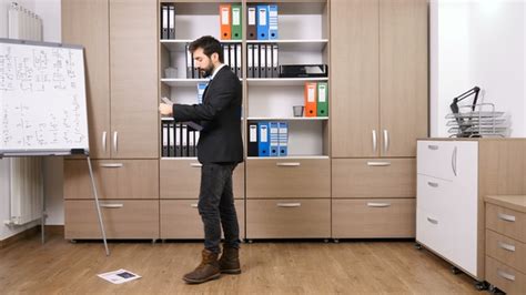 Stressed Businessman Throwing Papers From A Folder On The Floor Stock