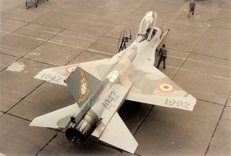 A Fighter Jet Sitting On Top Of An Airport Tarmac