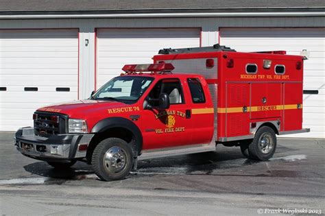 A Red Fire Truck Parked In Front Of A Garage