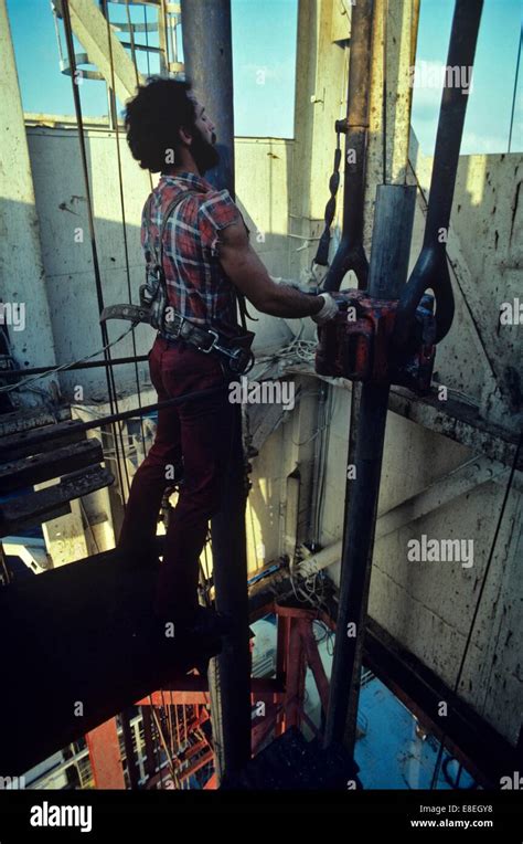 Offshore Oil Rig Worker Handling Drill Pipe In Derrick Stock Photo