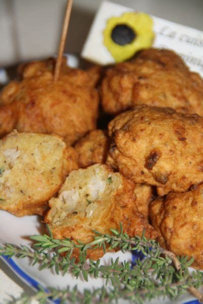 Some Fried Food Is On A Blue And White Plate With An Olive Sprig