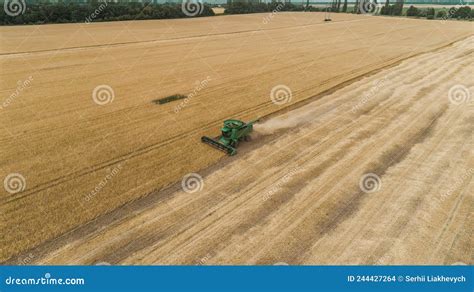 Aerial View Combine Harvester Harvesting On The Field Stock Photo