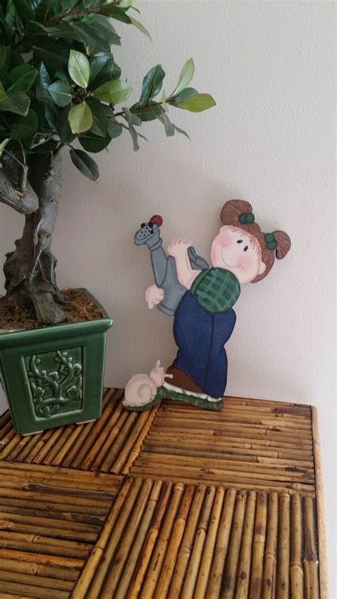 A Wooden Table Topped With A Potted Plant Next To A Small Figurine