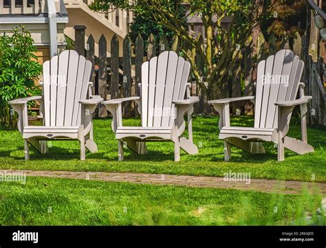 White Adirondack Chair Setting At The Garden Traditional Curveback