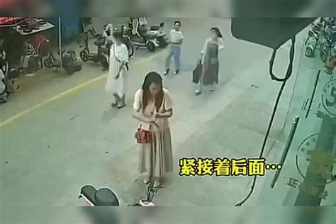 女子站路边擦手，忽然发觉头顶不对劲，监控拍下危险瞬间 监控 头顶 女子