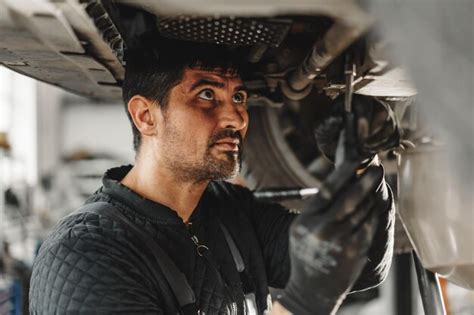 Premium Photo Workman Mechanic Working Under Car In Auto Repair Shop