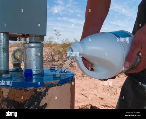 Bleach Being Poured Into A Well Head In An Effort To Clean Organic