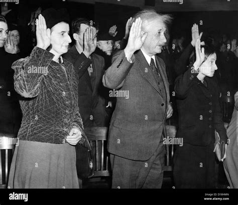 Albert Einstein taking his oath of citizenship. Also taking swearing allegiance in are Helen ...