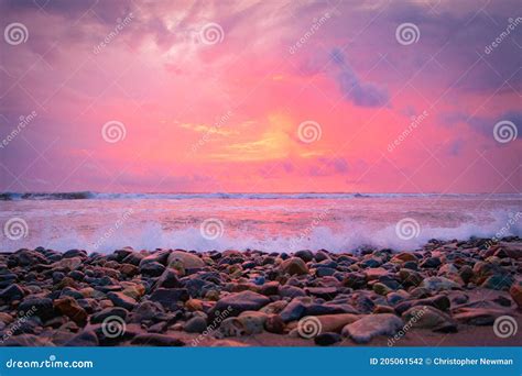 Beach Sunset with Waves Breaking on Shore Stock Photo - Image of scene ...