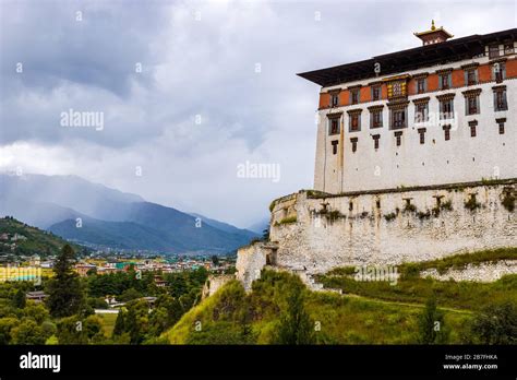 Rinpung Dzong Above The Paro Chu River Valley And Town Buildings On A