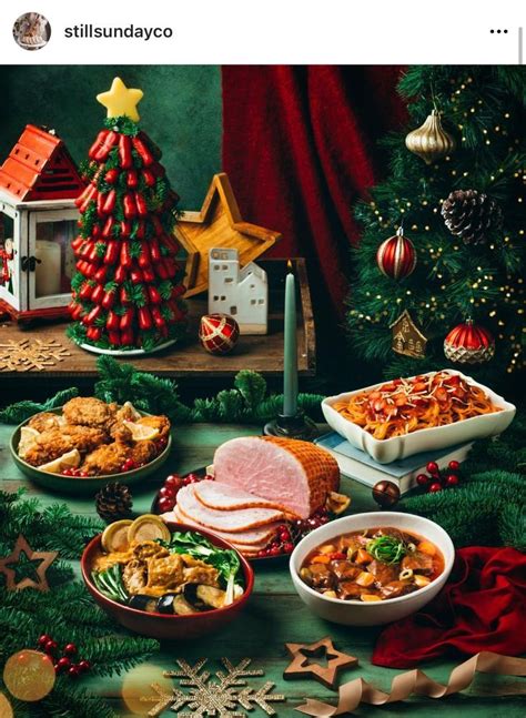 A Table Topped With Lots Of Food Next To A Christmas Tree