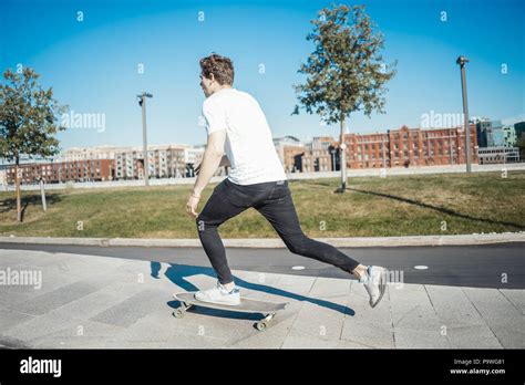 Young Attractive Man Riding Longboard In The Park Stock Photo Alamy