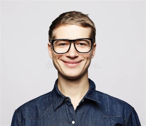 Portrait Of A Smart Young Man Wearing Eyeglasses Standing Against White